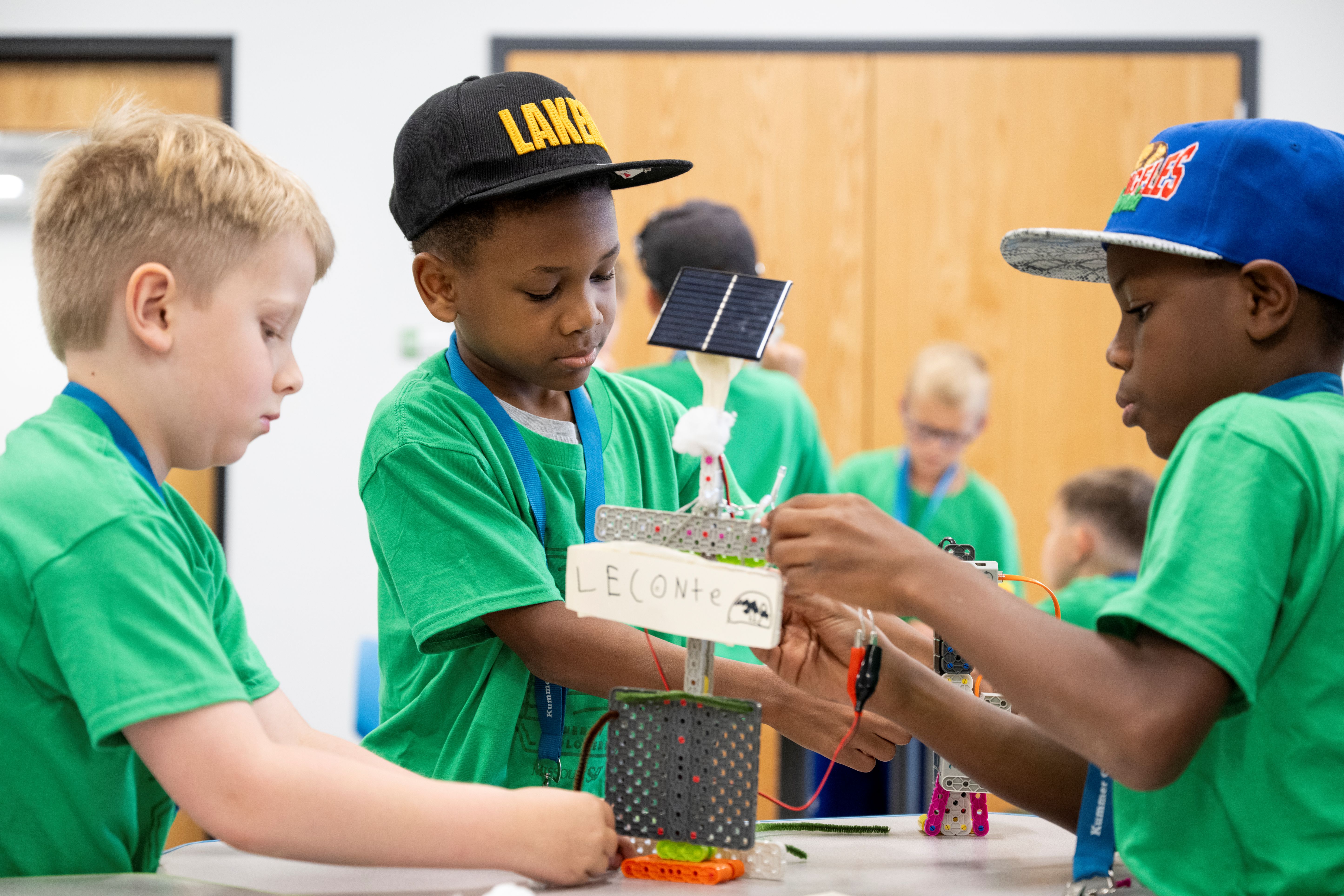 Boys are doing STEM Activity at Energy Explorers Day Camp with mini solar panels